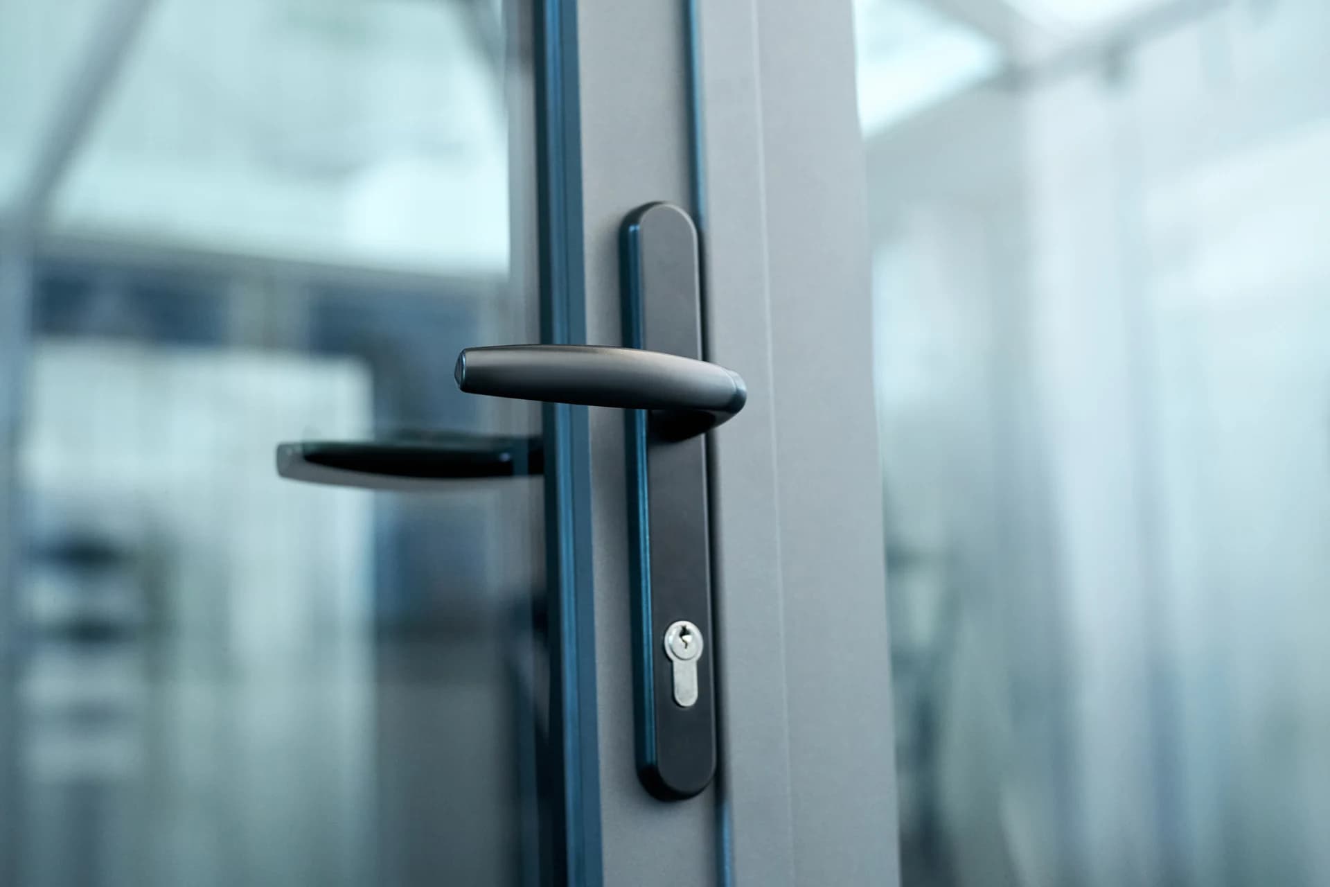 Close-up of an anthracite grey door with a black handle and multipoint lock in Bridgend