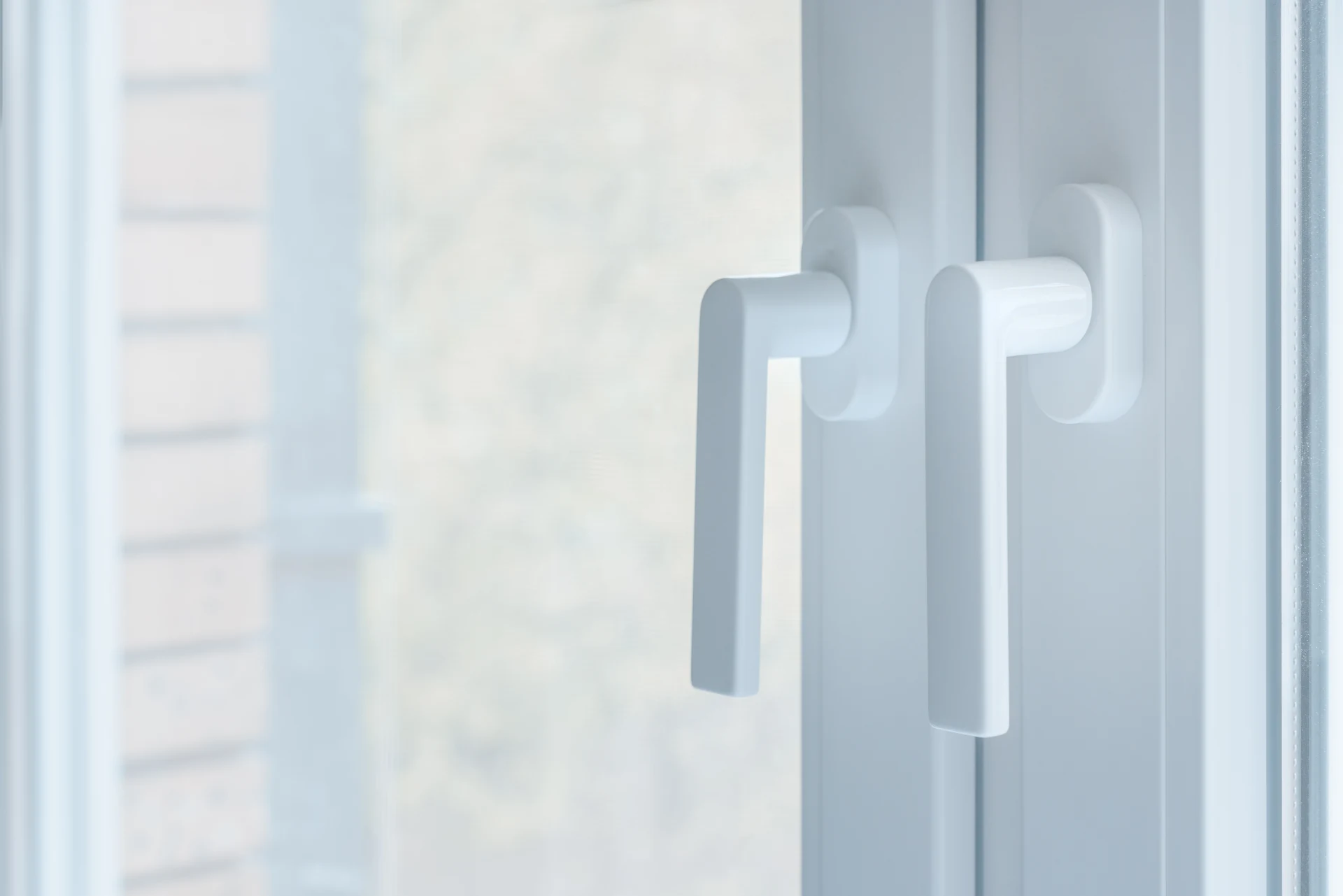 Close-up of white uPVC window handles fitted in Pontardawe