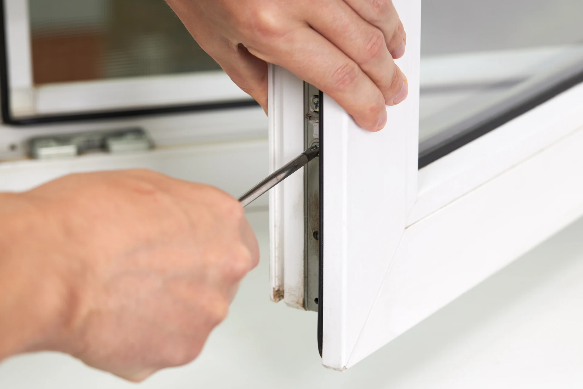 Bully Windows fitter installing a white uPVC window frame in Swansea